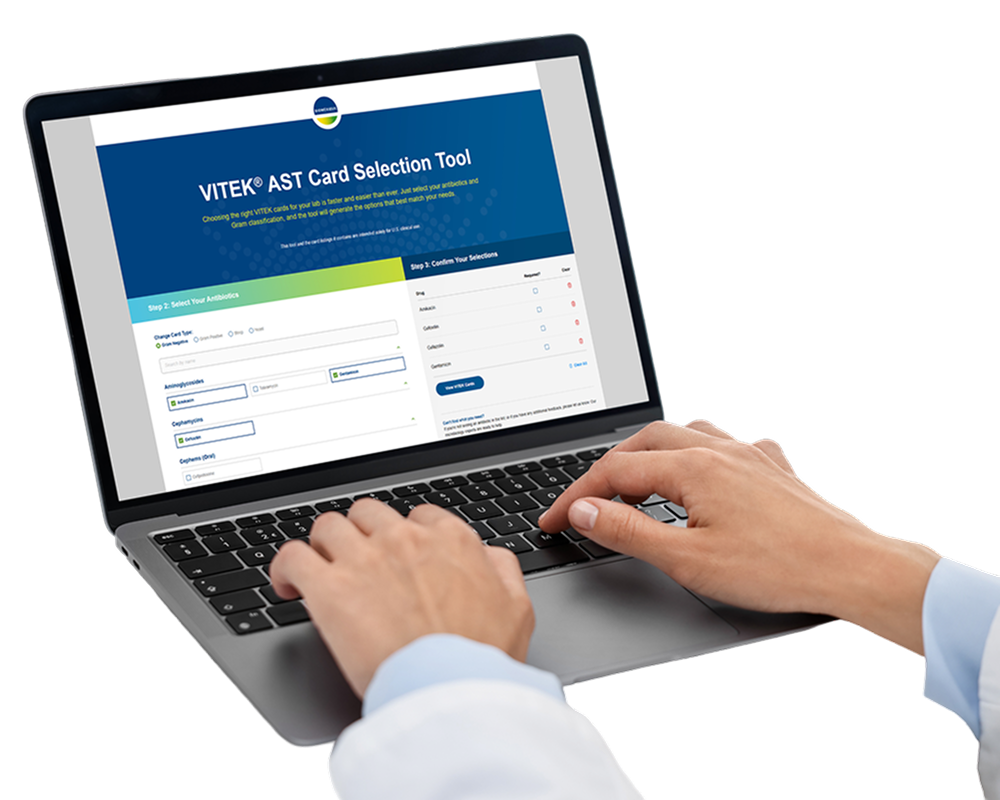 Healthcare professional using VITEK AST Card Selection on laptop